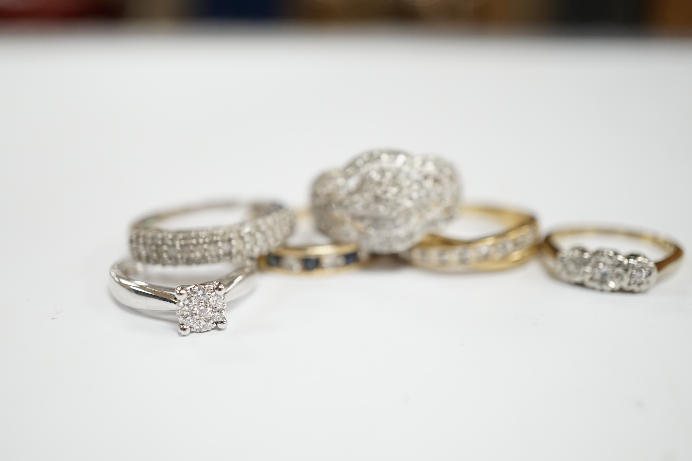 Five assorted modern 9ct and gem set rings including diamond chip cluster and sapphire and diamond chip, gross weight 12.7 grams, together with a 925 and diamond chip cluster set ring.